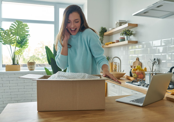Woman unpacking clean household products in her kitchen
